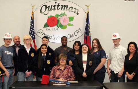 Mayor McDaniel and student members of CTAE clubs at the signing of the CTAE Month Proclamation